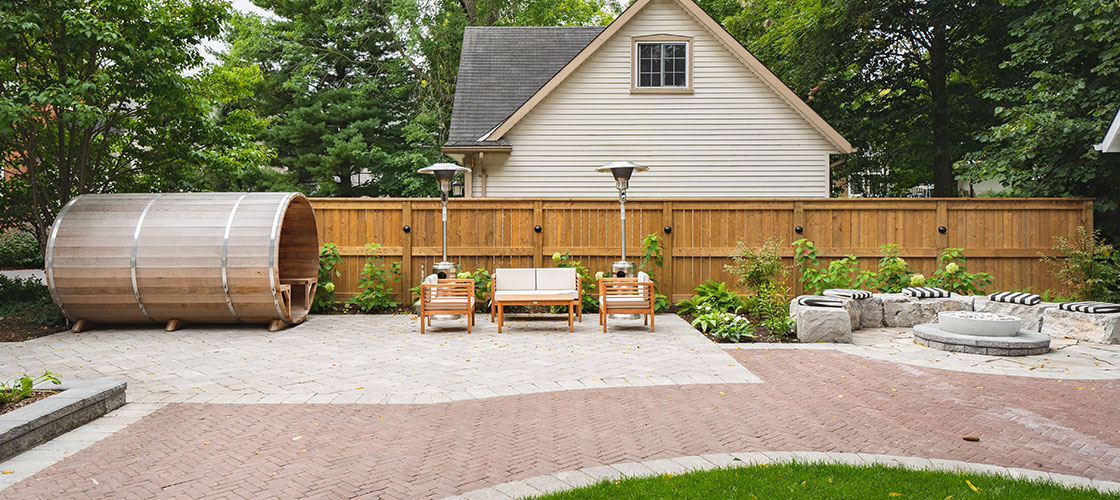 Backyard patio with interlock and sauna