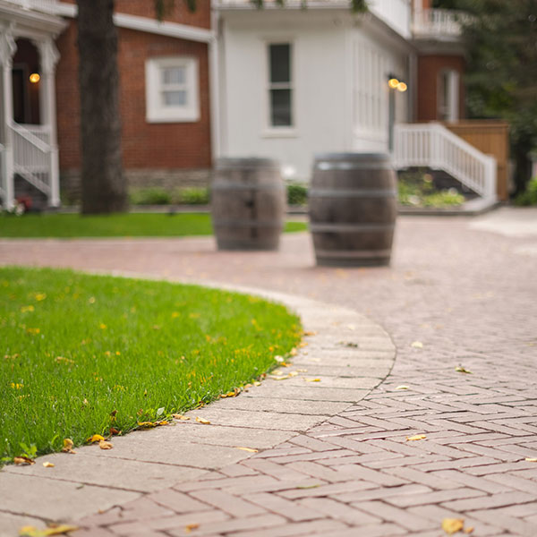 A close up of interlocking pathway leading up to a house